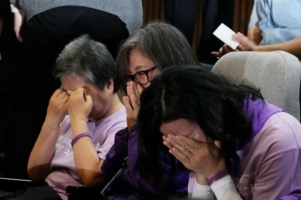 Bereaved family members of the victims of the Halloween crush in 2022 react at the National Assembly in Seoul (AP)