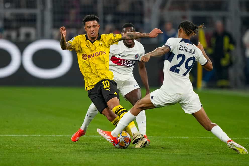 PSG’s Bradley Barcola, right, and Dortmund’s Jadon Sancho (AP)